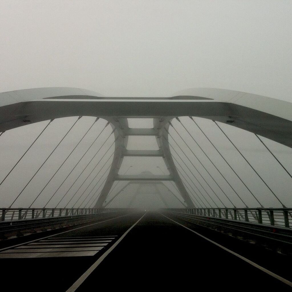 Empty modern bridge during foggy weather