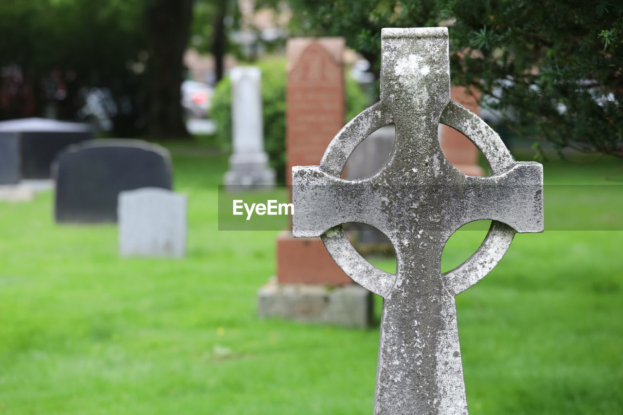 Close-up of cross against stone wall