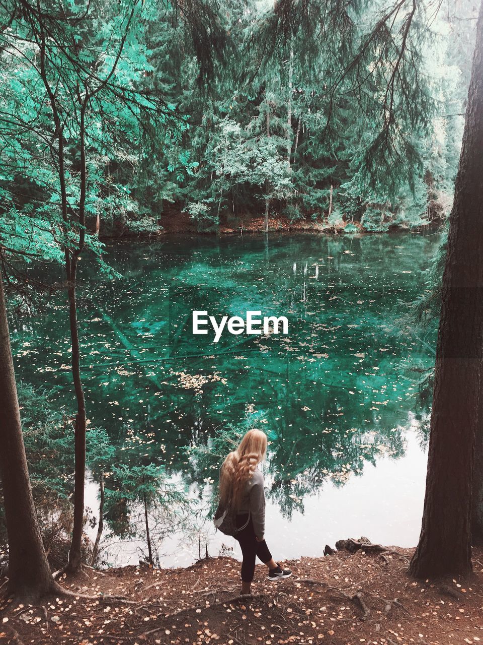 WOMAN STANDING IN FOREST