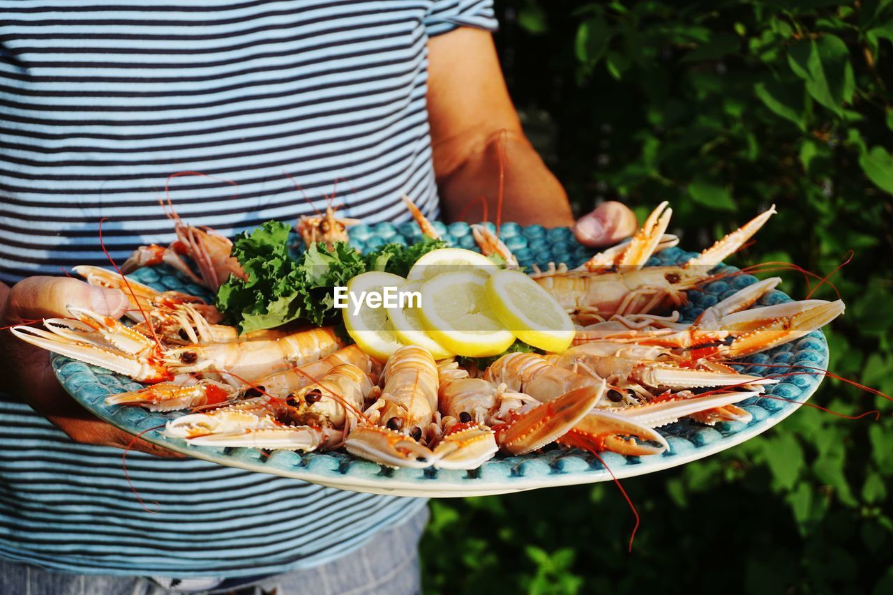 Man serving crayfish at a garden party