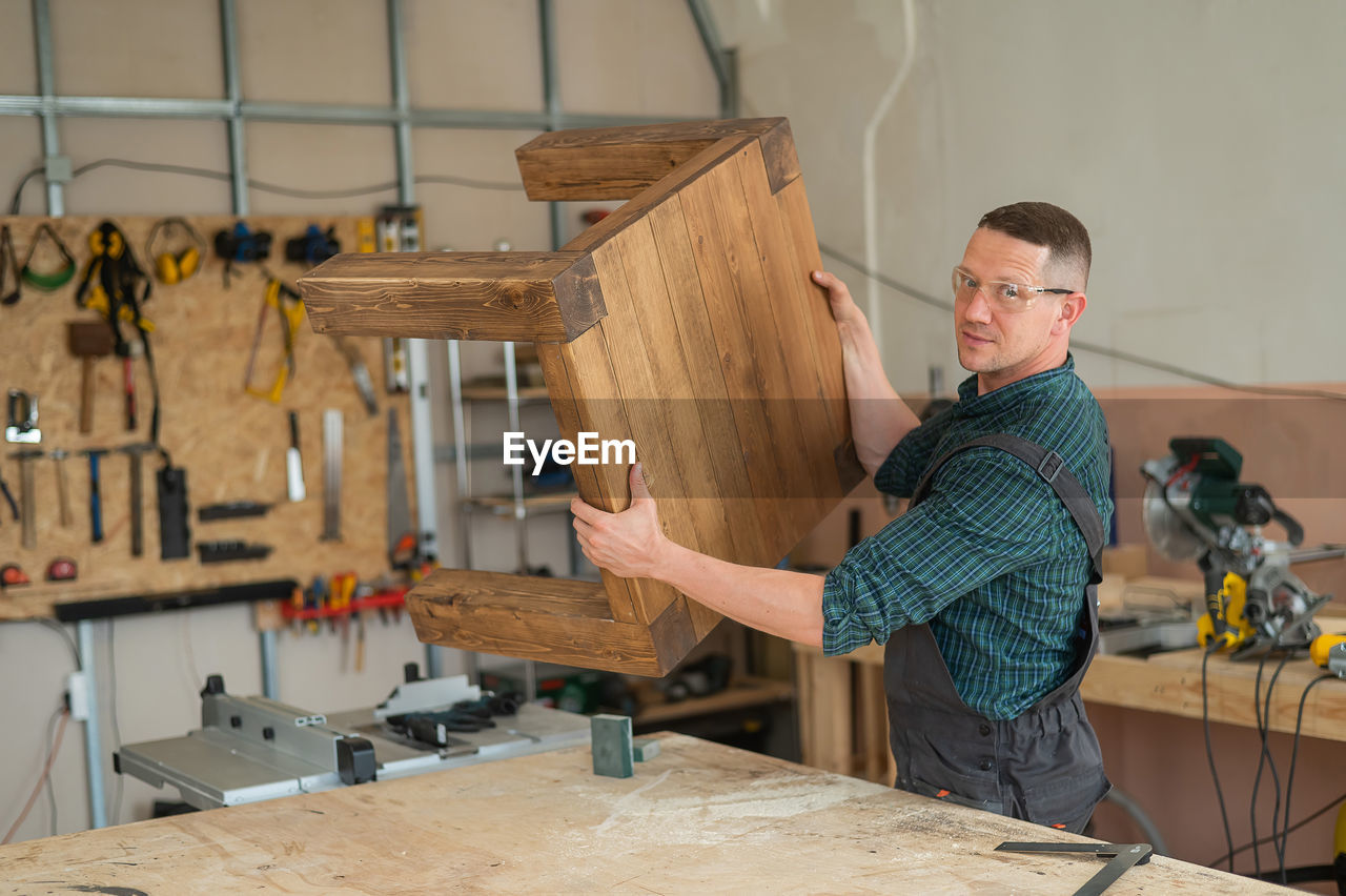 side view of man working at workshop