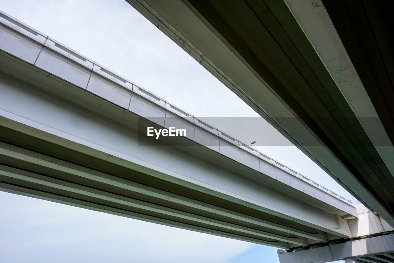 Low angle view of penang bridge against sky in city