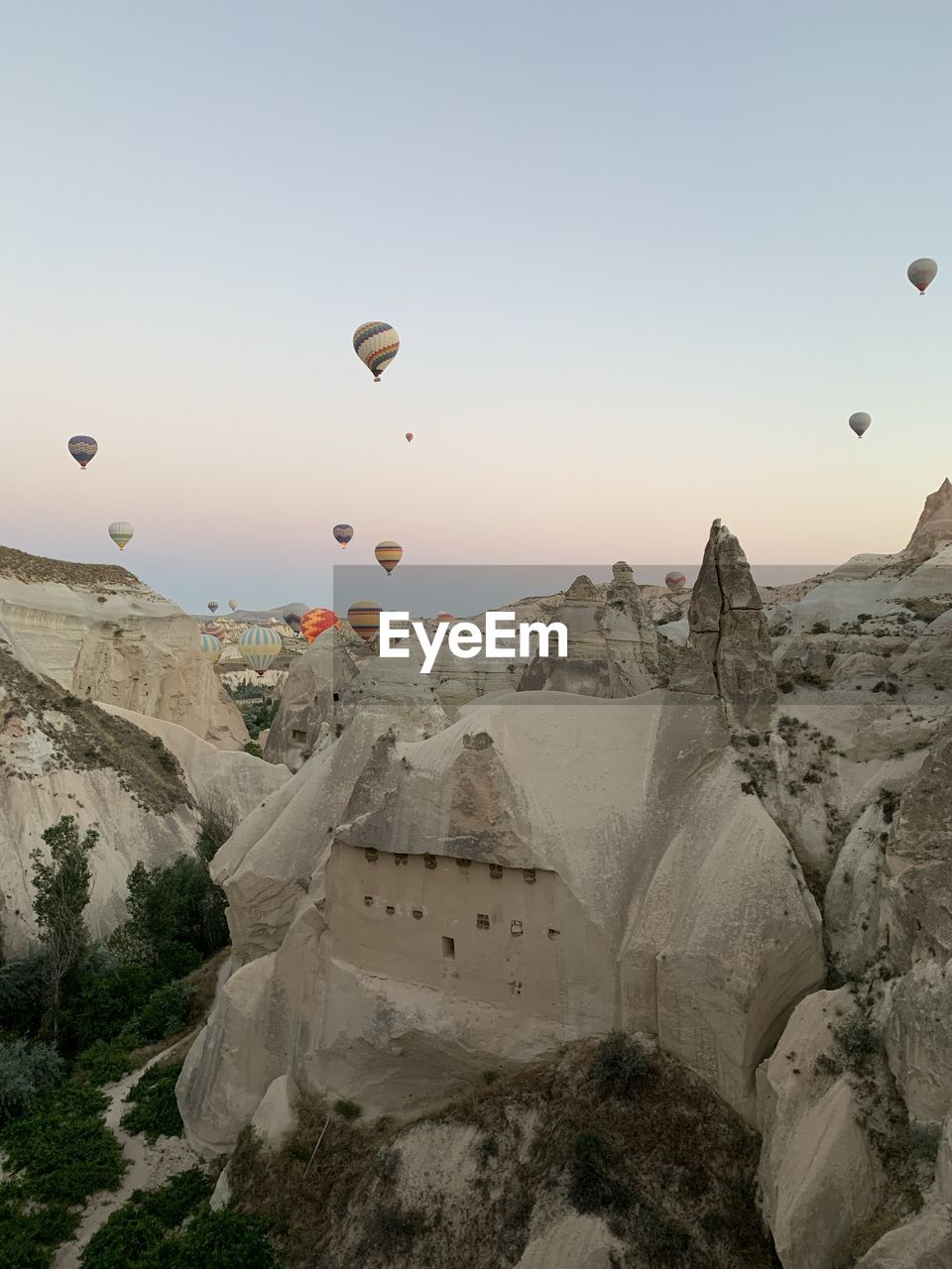 View of hot air balloon flying over mountains against sky