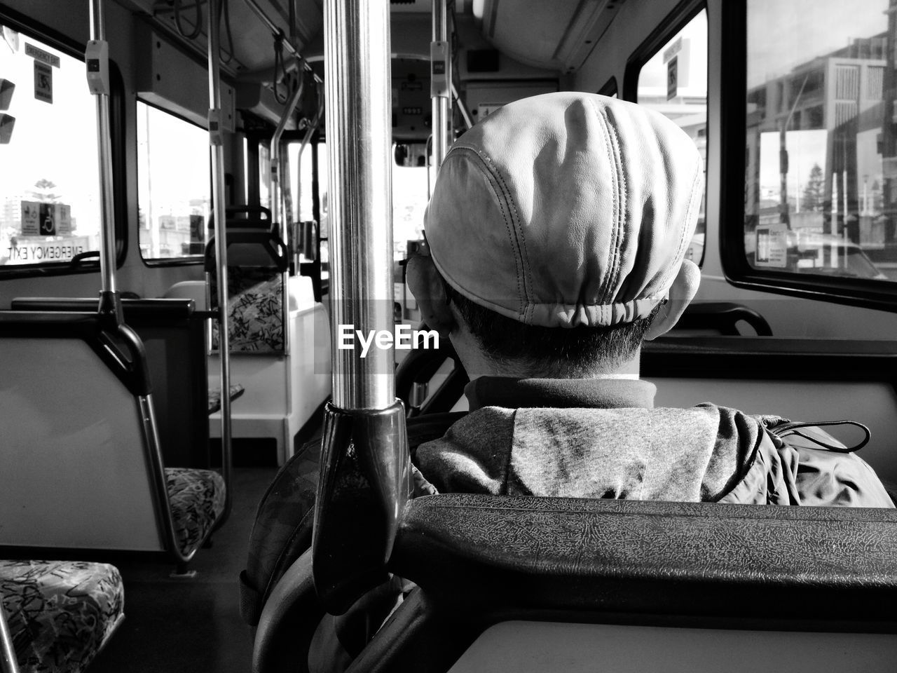 Close-up rear view of man in bus