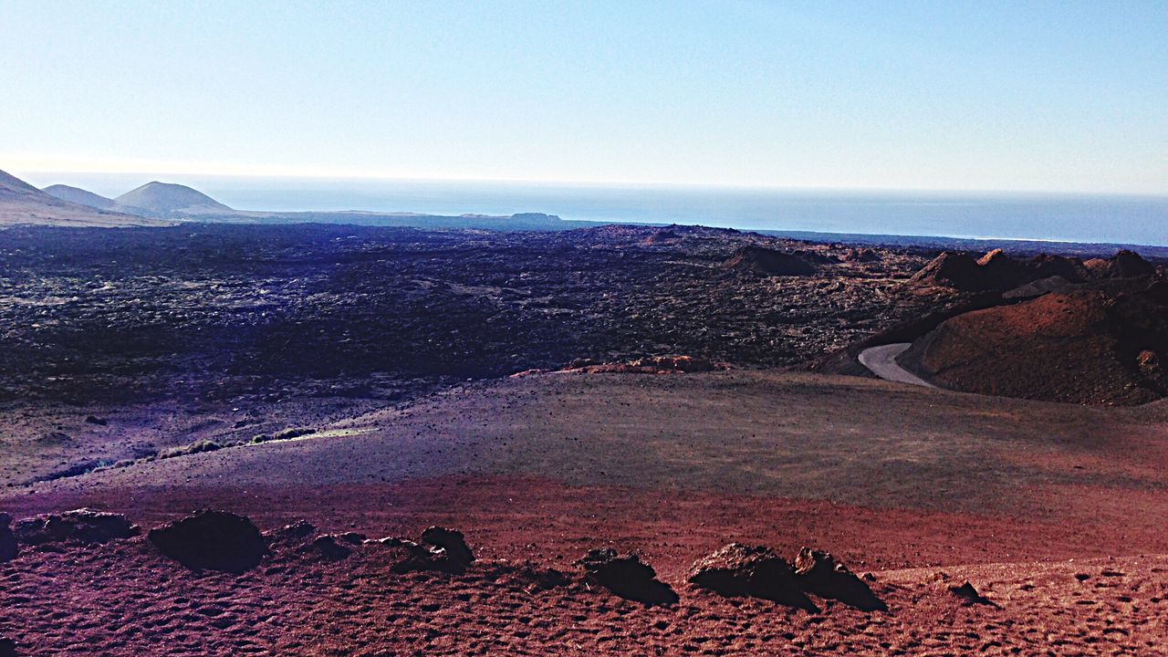 Scenic view of barren landscape against clear sky