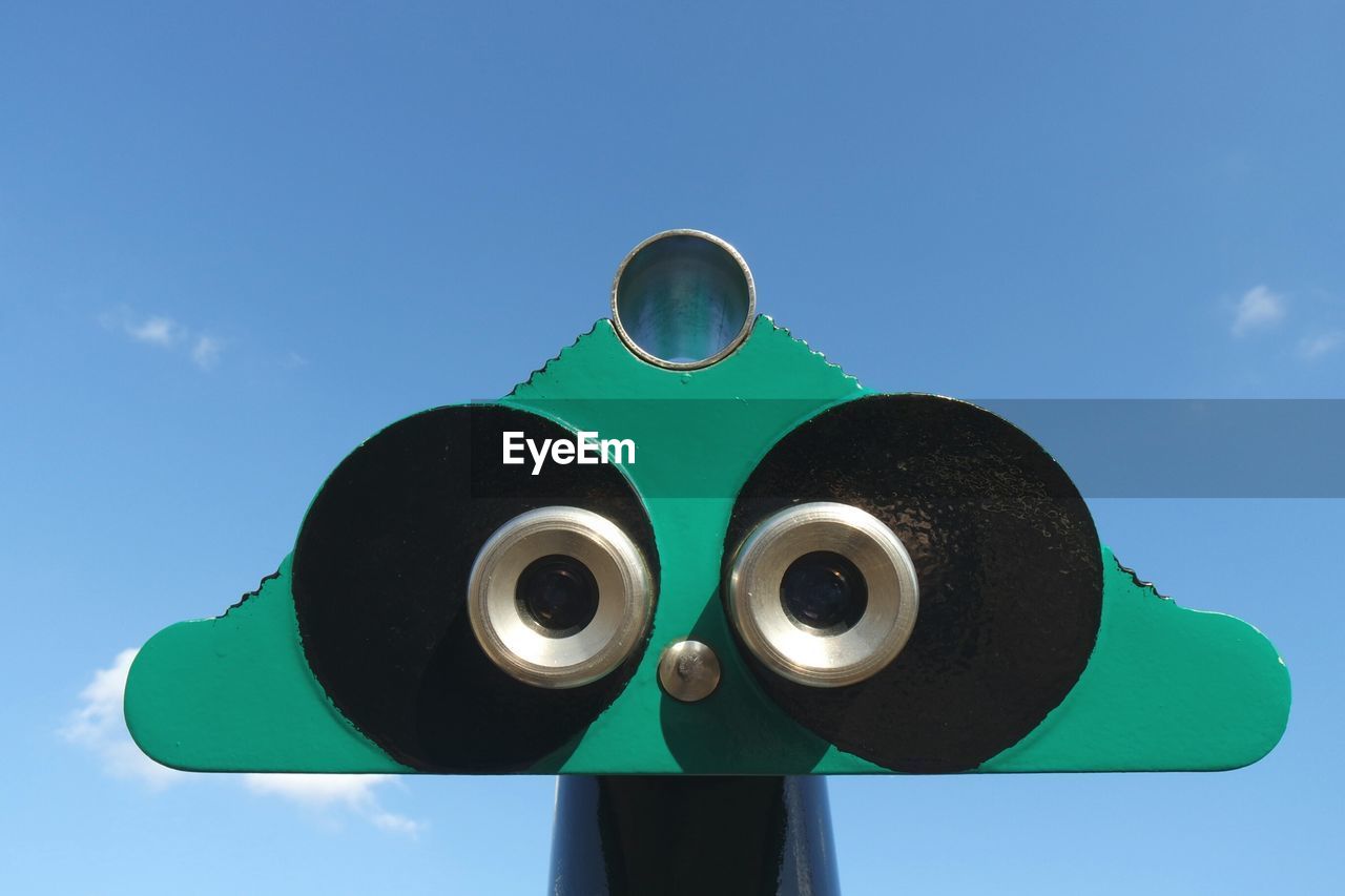 Close-up of binoculars facing the sky
