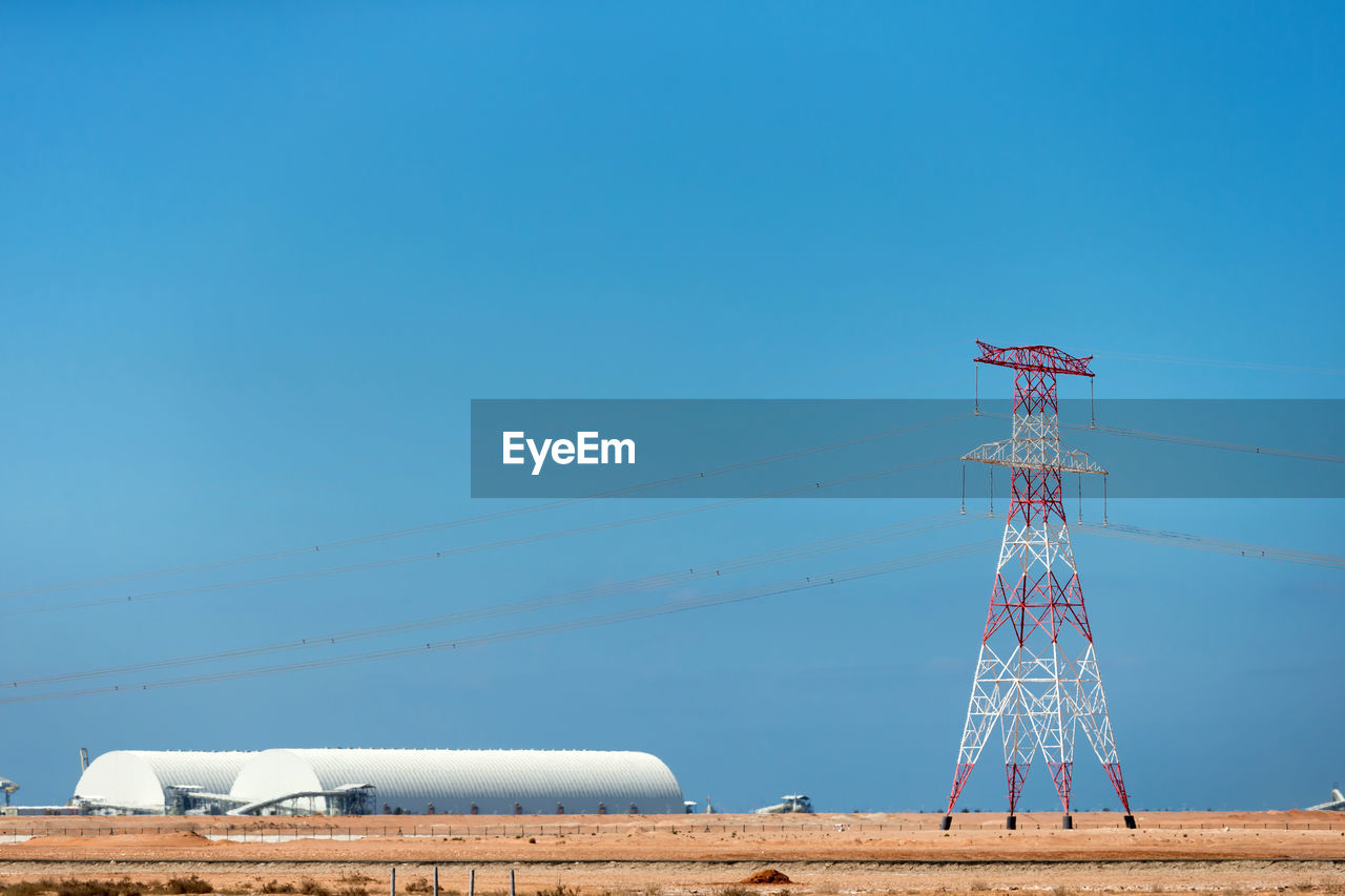 LOW ANGLE VIEW OF WINDMILL AGAINST CLEAR BLUE SKY