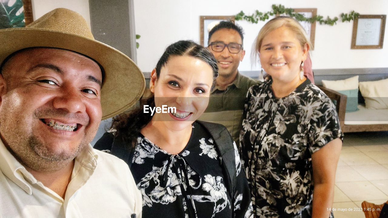 smiling, portrait, happiness, adult, group of people, looking at camera, person, emotion, togetherness, women, men, clothing, fashion accessory, female, human face, cowboy hat, hat, mature adult, indoors, cheerful, lifestyles, bonding, family, senior adult, headshot, sun hat, fedora, positive emotion, friendship, child, fun, small group of people, parent, domestic life, enjoyment, love, father, home interior, domestic room, casual clothing, childhood, young adult, seniors, celebration