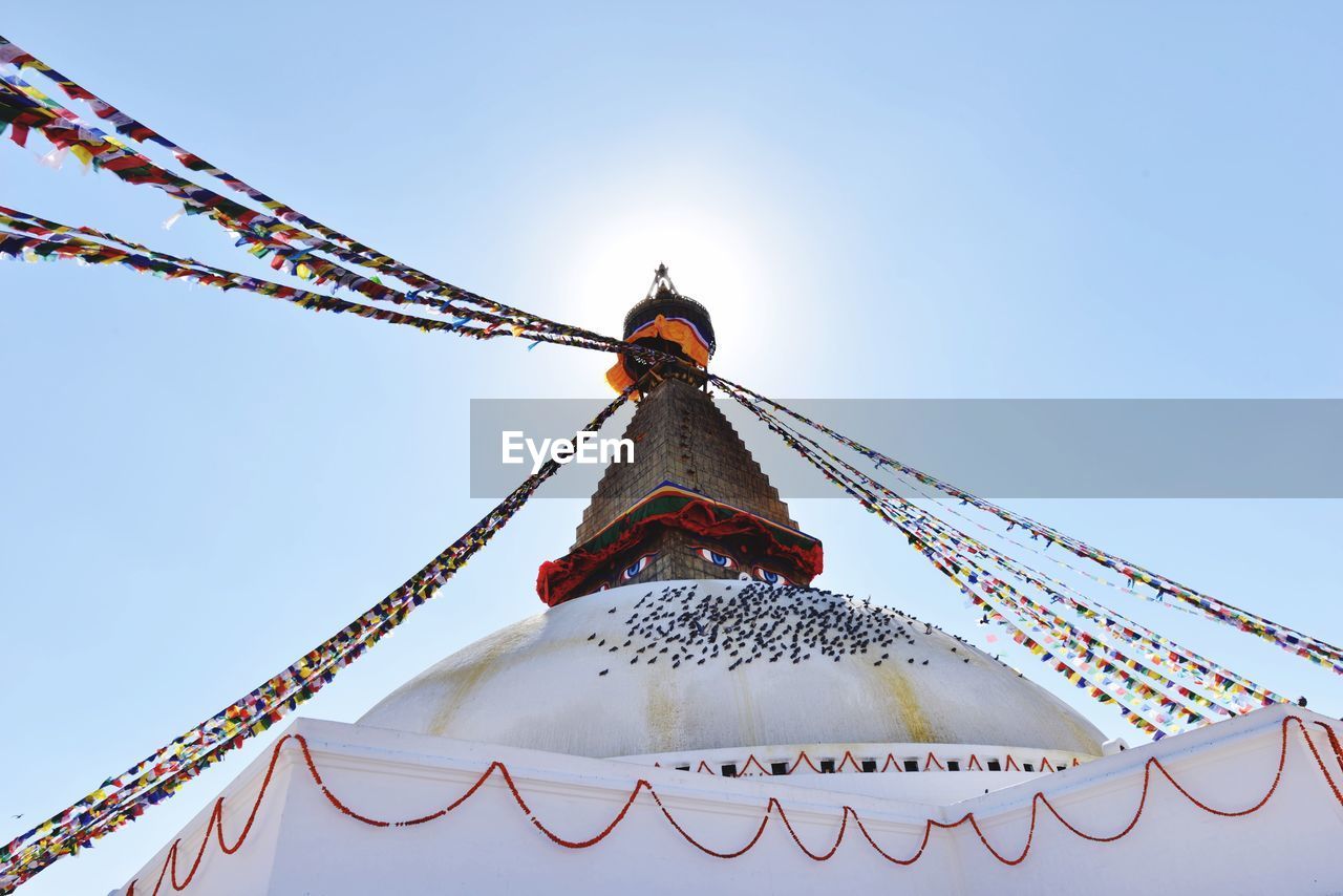 LOW ANGLE VIEW OF CAROUSEL AGAINST SKY