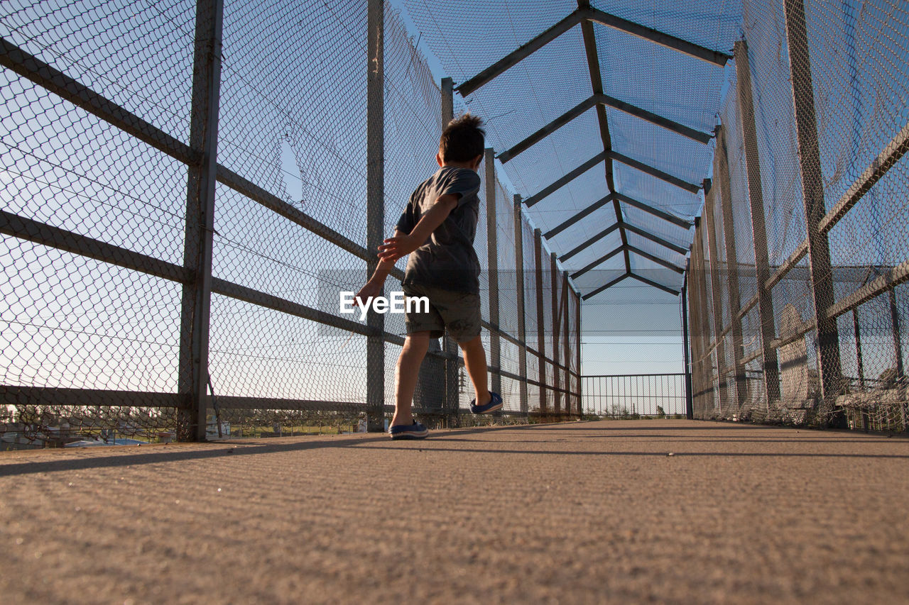 Low angle view of child walking in city