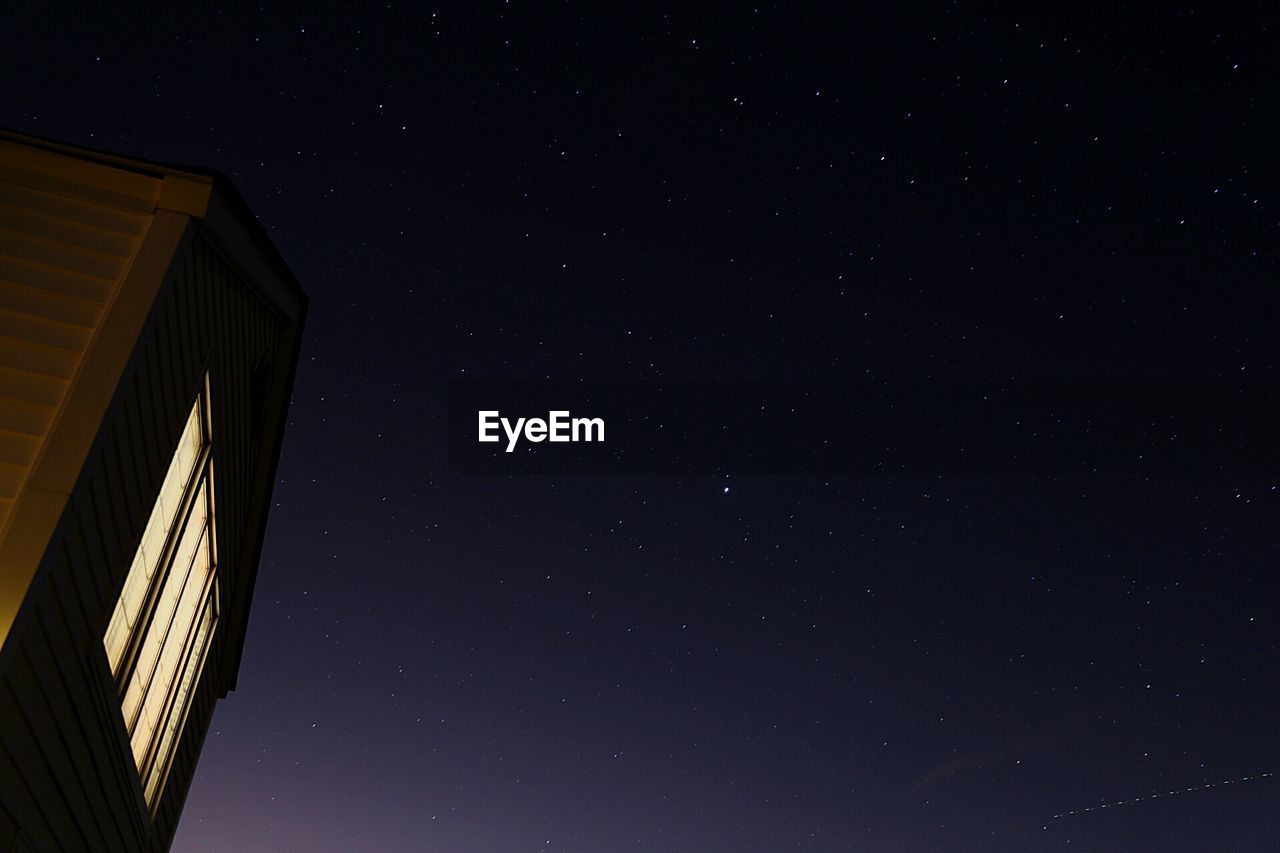 LOW ANGLE VIEW OF BUILT STRUCTURE AT NIGHT