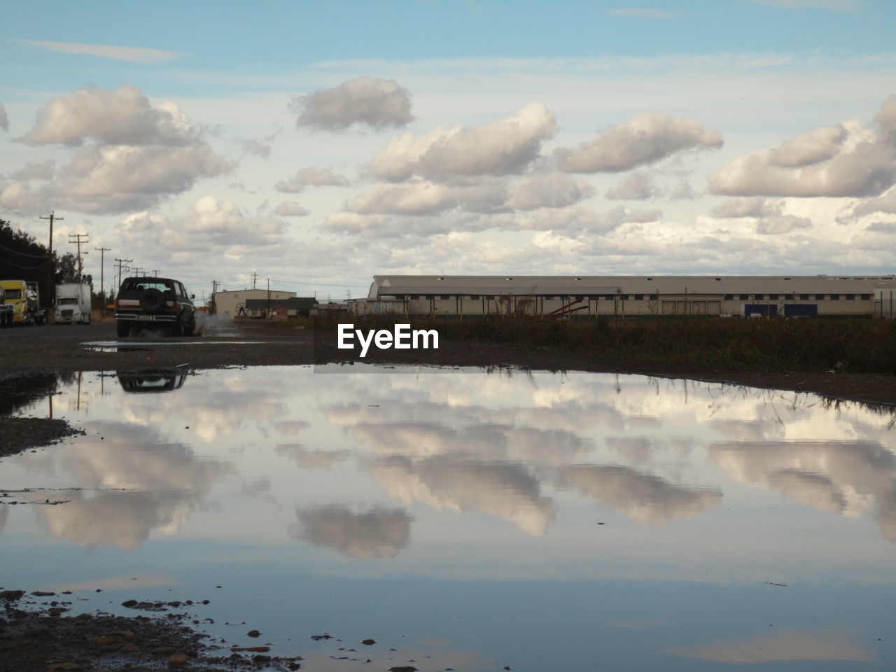 Puddle on street against sky