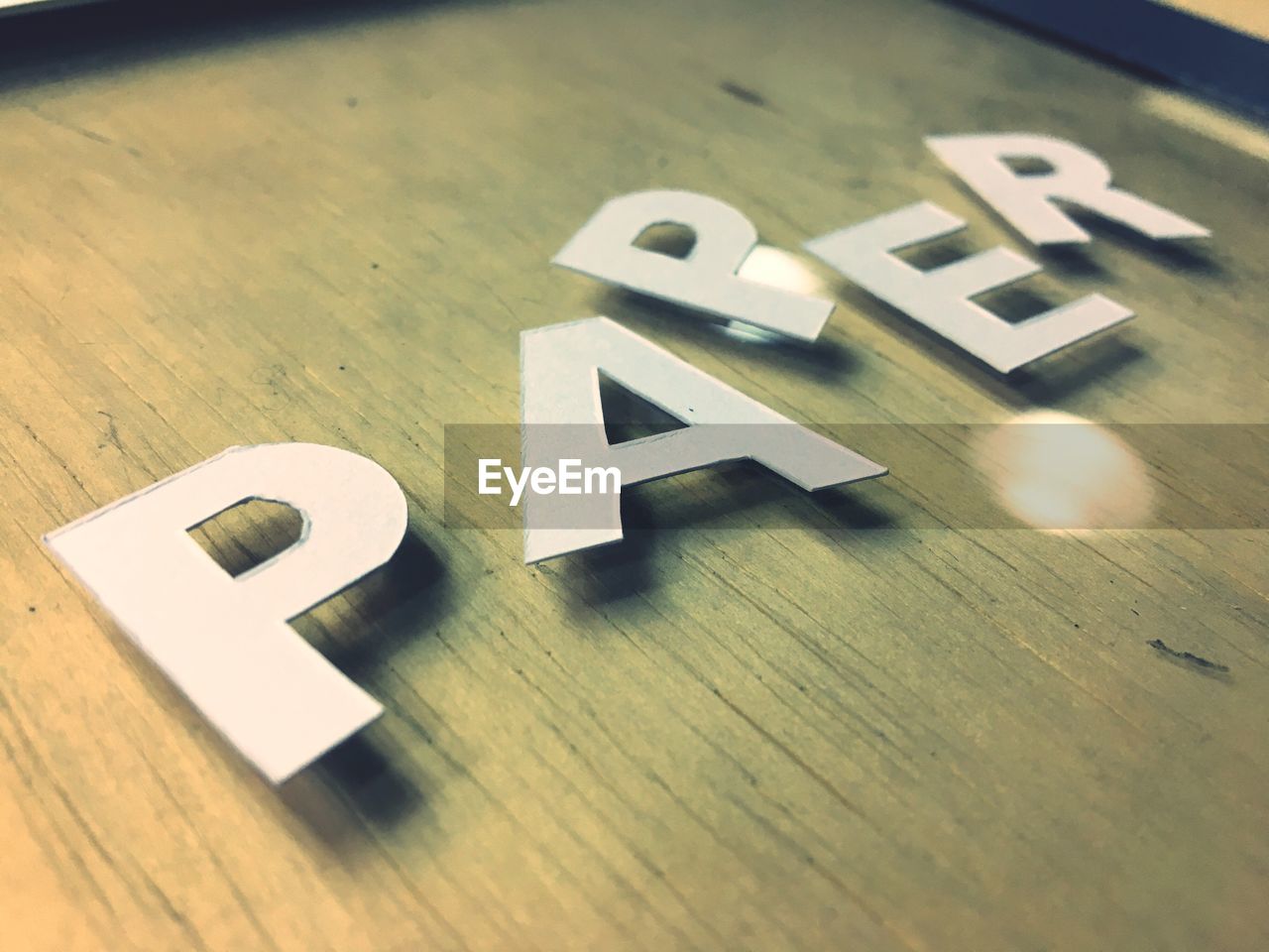 CLOSE-UP OF TEXT ON WOODEN SURFACE