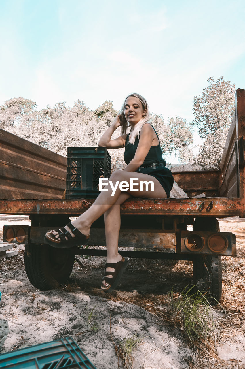 Woman sitting on truck