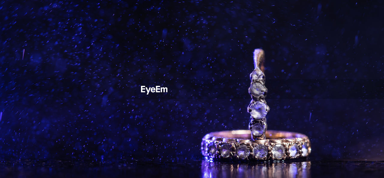 Close-up of rings against colored background