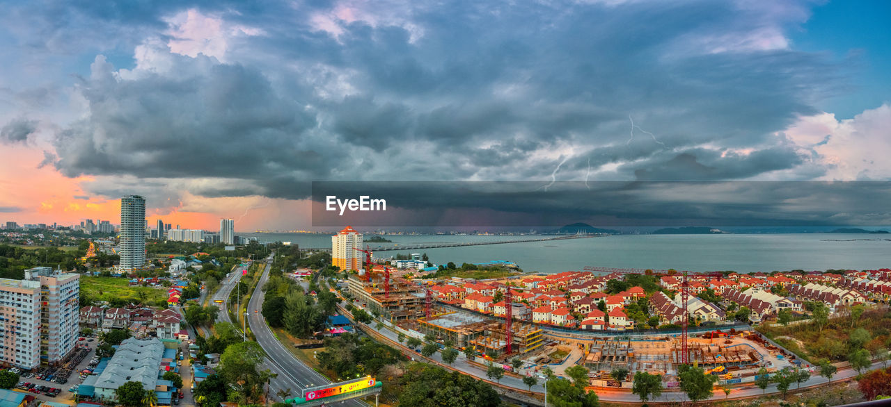 High angle view of road by buildings against sky