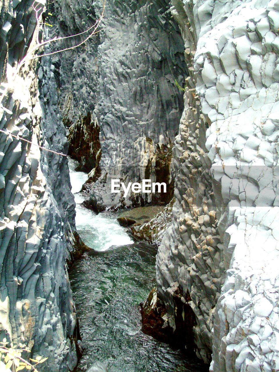 Stream flowing through rocks in winter