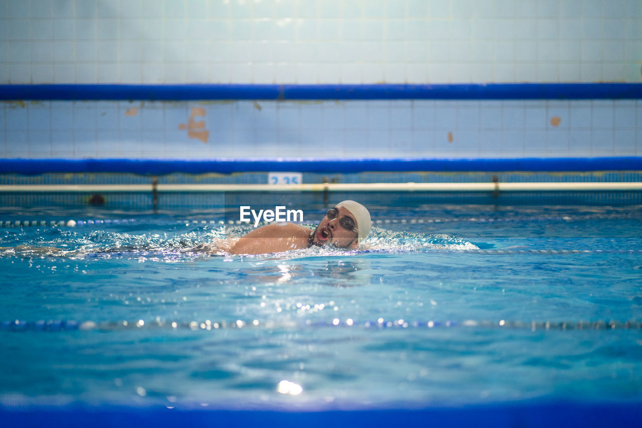 Man swimming in pool