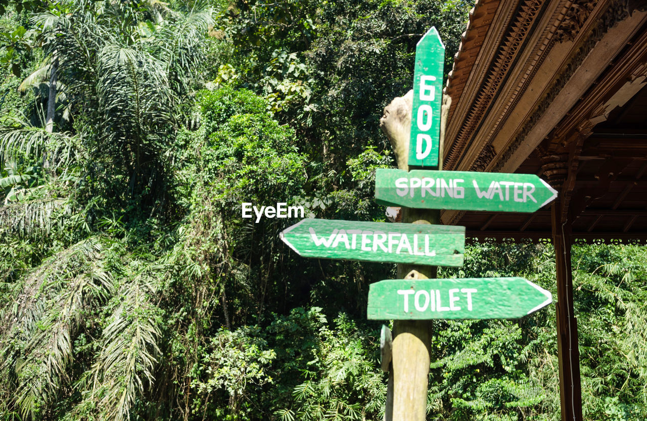 LOW ANGLE VIEW OF INFORMATION SIGN AGAINST TREES