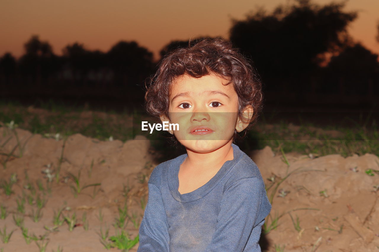 Indian little child royalty free photo with blur background of sunset in india