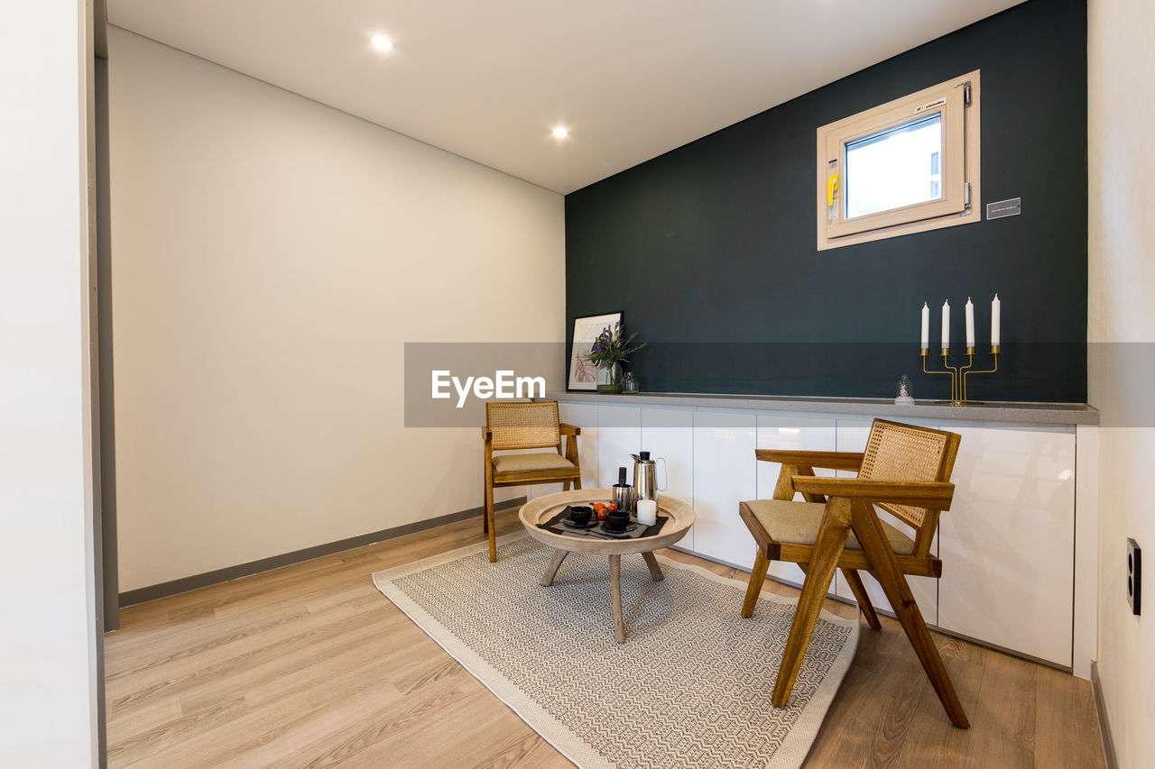 EMPTY CHAIRS AND TABLES ON HARDWOOD FLOOR