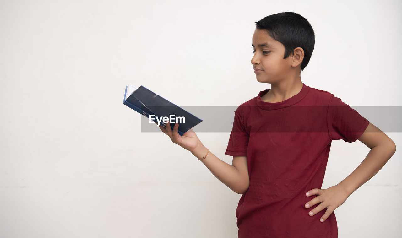 FULL LENGTH OF BOY USING MOBILE PHONE