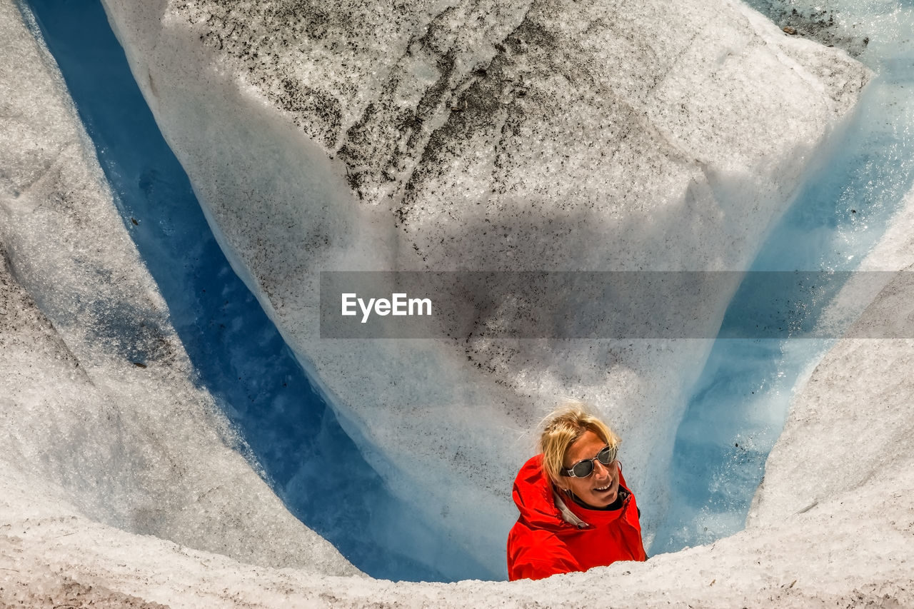 Portrait of woman climbing on snow covered mountain