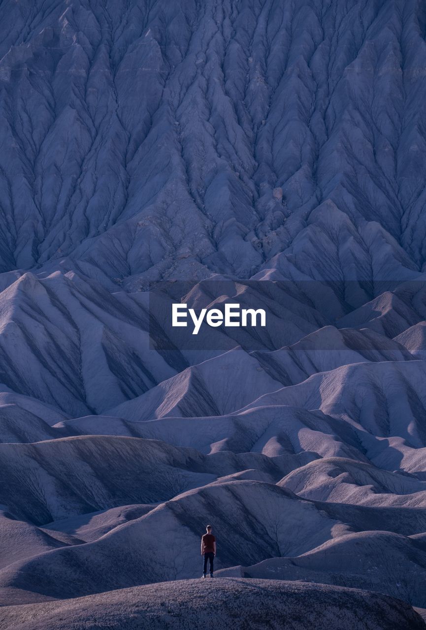 Rear view of man on snowcapped mountains