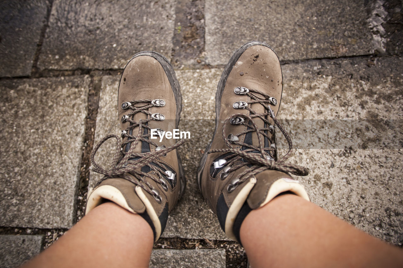 shoe, low section, human leg, personal perspective, black, one person, limb, standing, human limb, footwear, lifestyles, high angle view, spring, white, adult, directly above, footpath, day, city, leisure activity, human foot, street, outdoors, men, casual clothing, fashion, hand