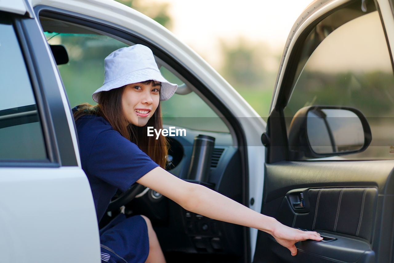 Woman wearing hat while sitting in car