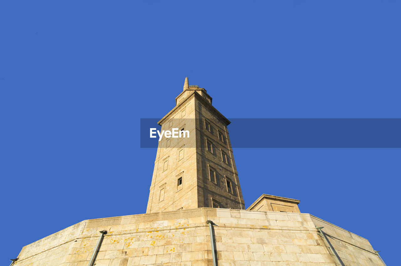 Tower of hercules against clear blue sky