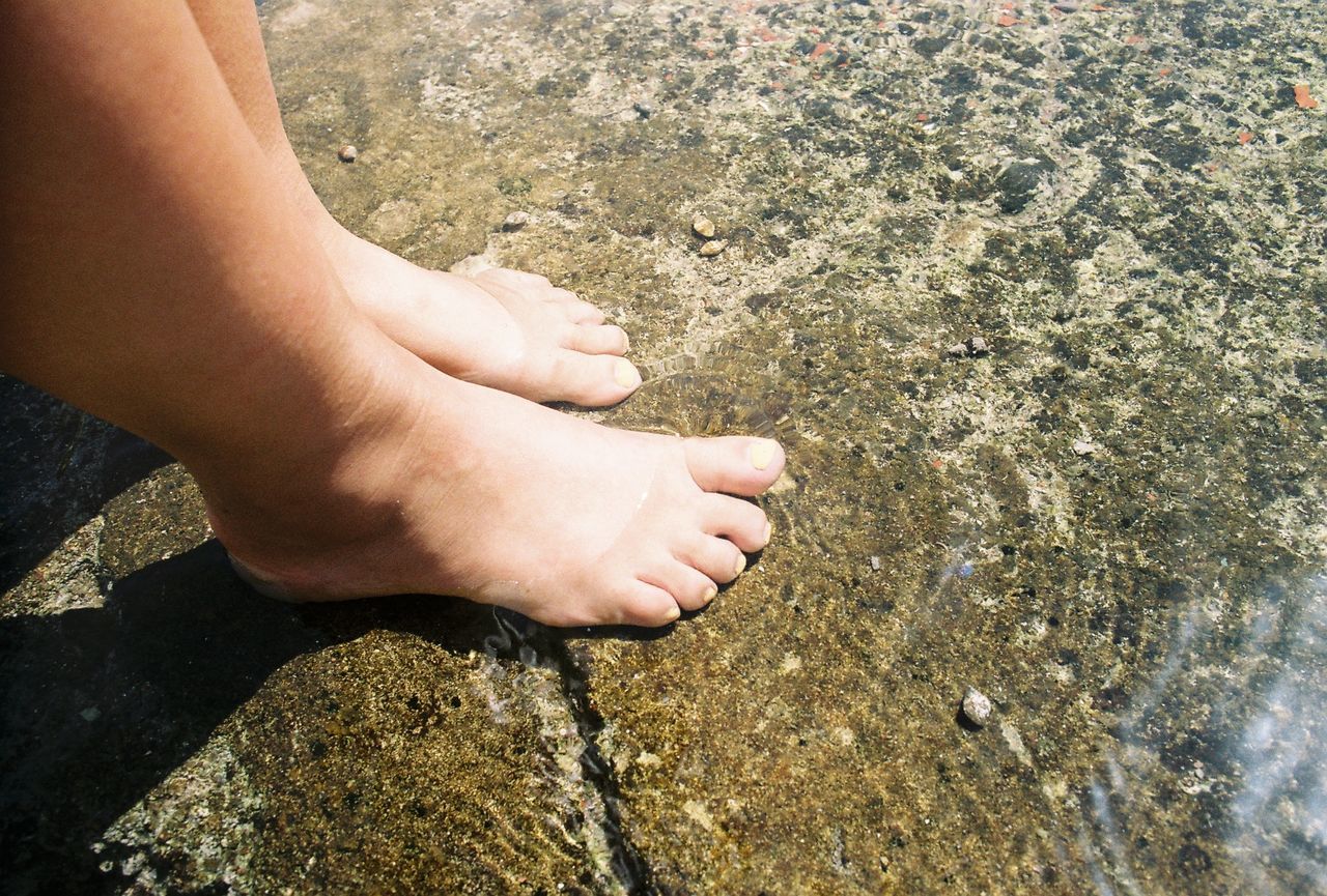 Low section of man hand on rock