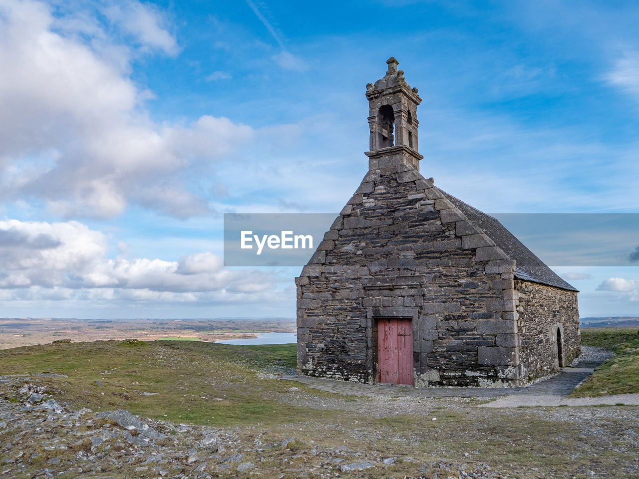 architecture, cloud, sky, built structure, landscape, building exterior, history, nature, the past, building, tower, religion, travel destinations, land, environment, rural area, scenics - nature, place of worship, rural scene, no people, grass, spirituality, belief, travel, old, non-urban scene, blue, horizon, day, outdoors, rock, tourism, beauty in nature, tranquility, plant, abandoned, landmark, remote, business finance and industry, tranquil scene, water