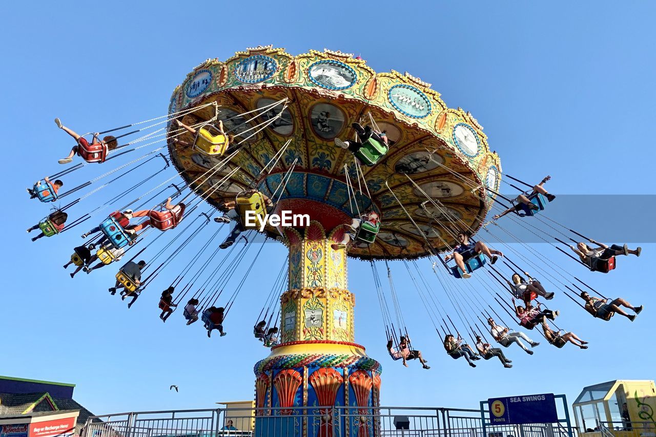 Low angle view of ferris wheel against clear sky