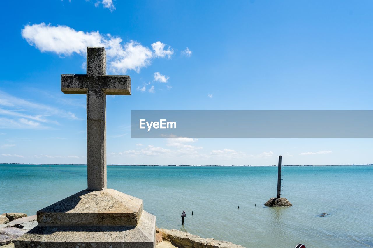 CROSS ON SEA AGAINST SKY