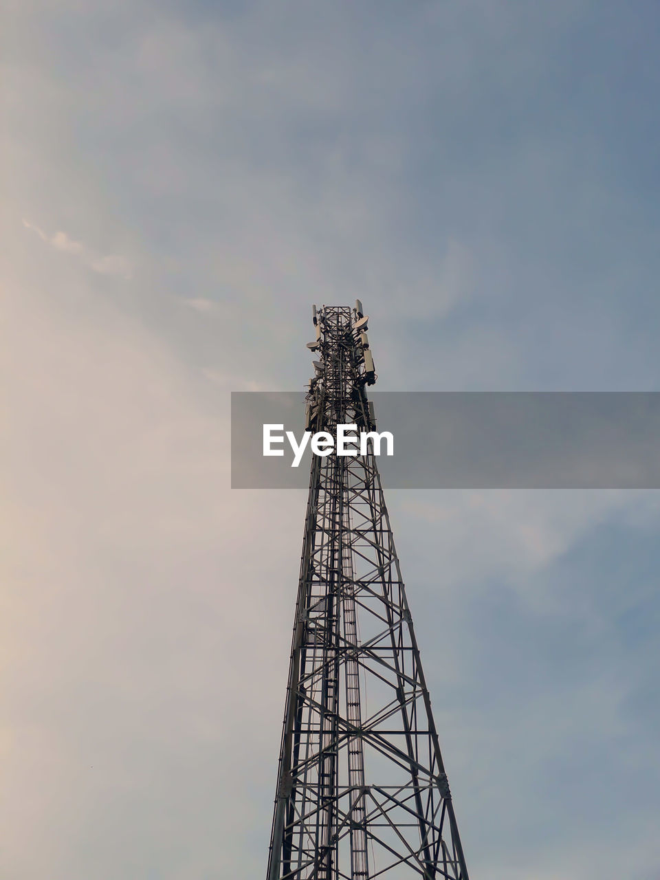 Low angle view of communications tower against sky