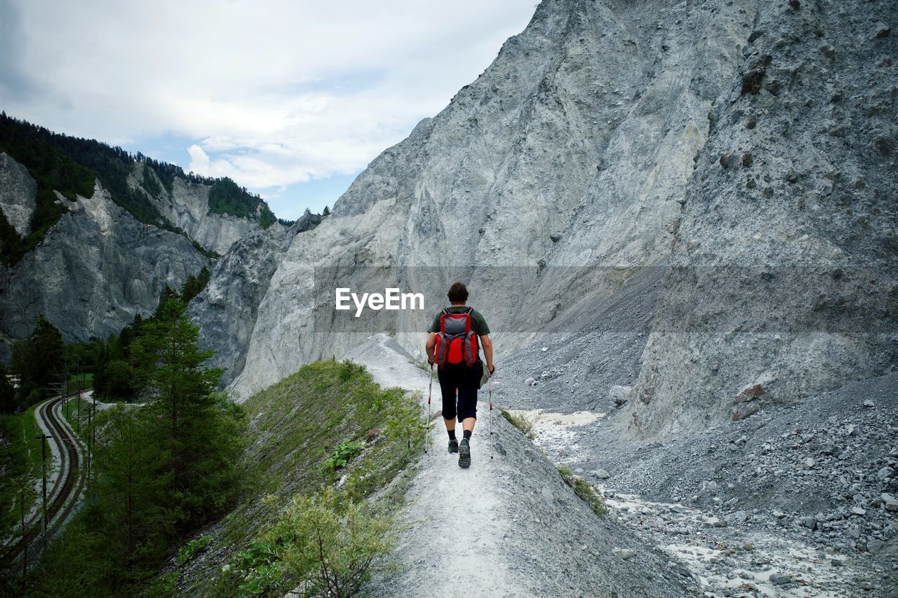 Rear view of man walking on mountain