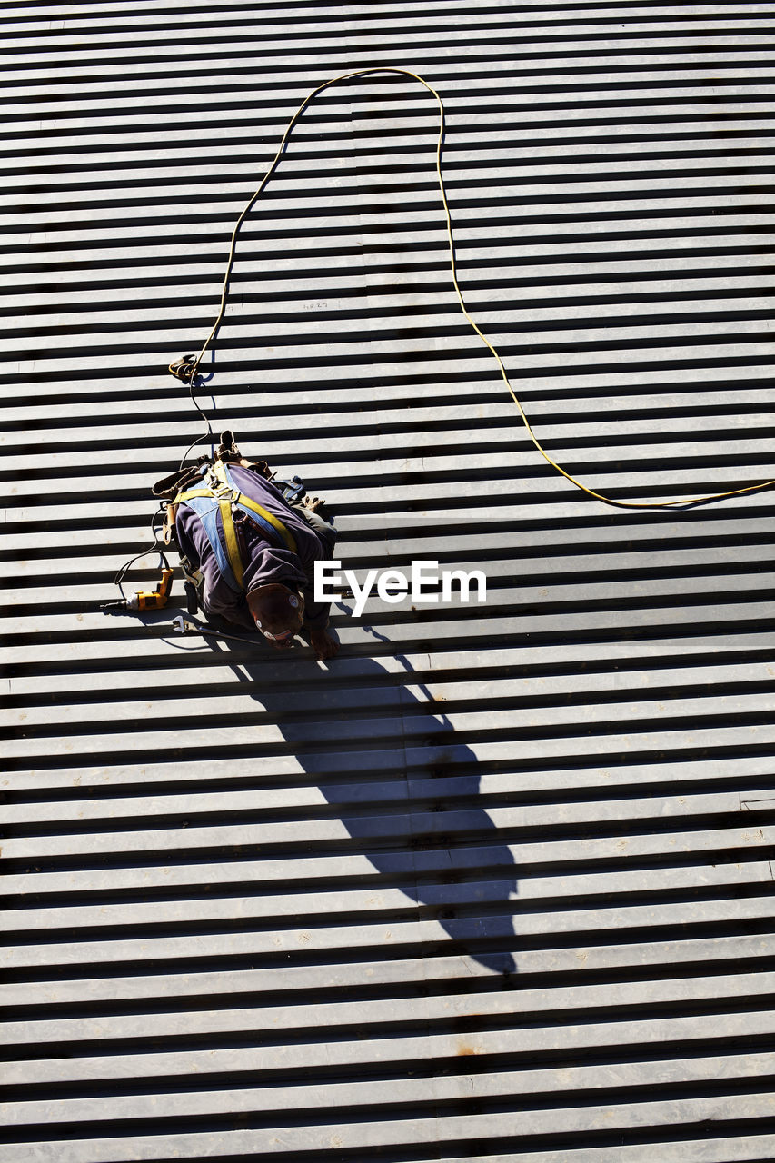 High angle view of manual worker working welding at construction site