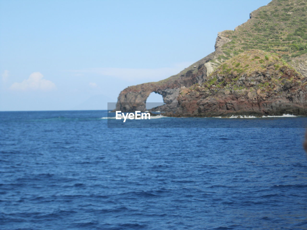 SCENIC VIEW OF SEA AND CLIFF AGAINST SKY