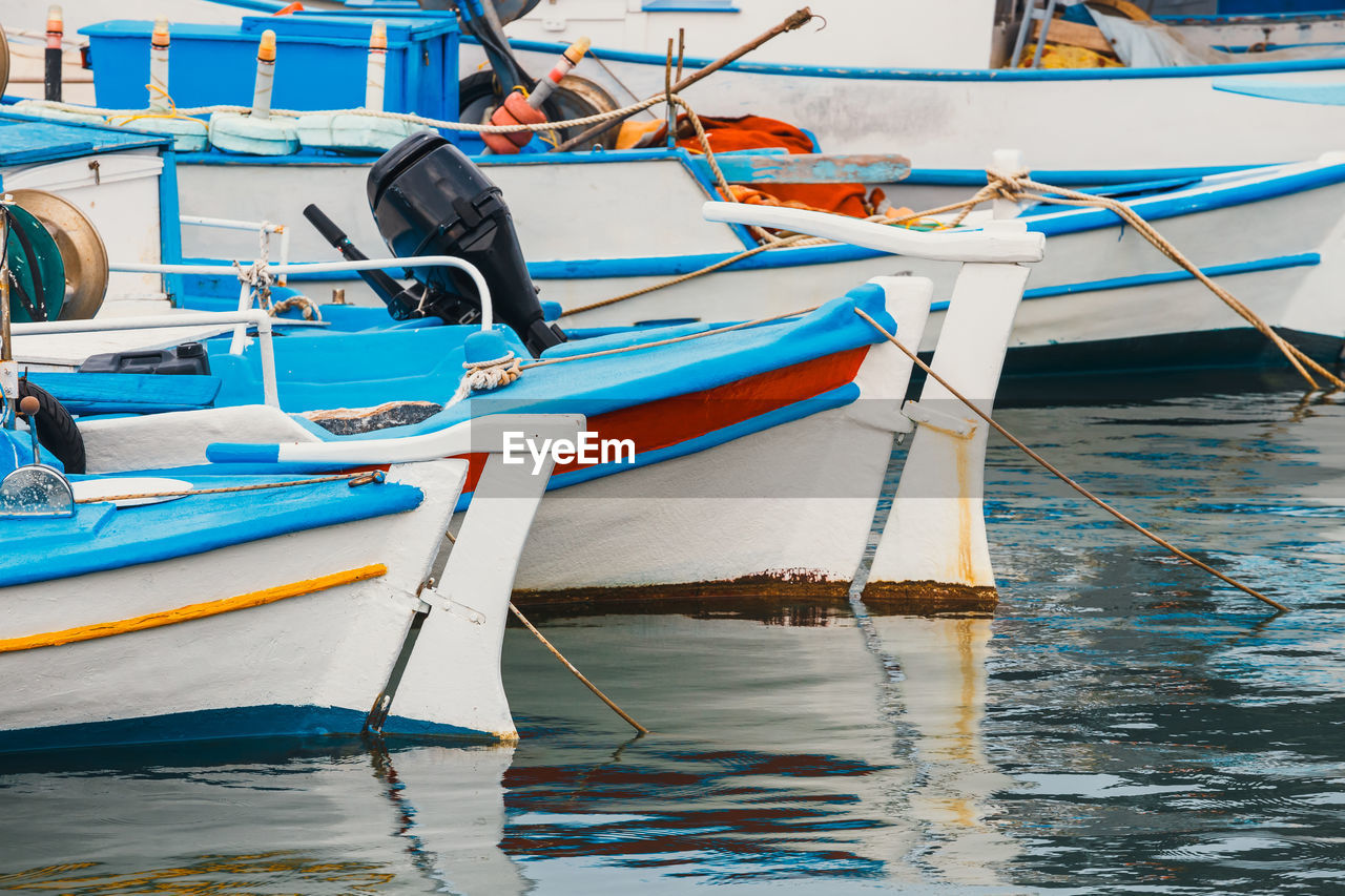 VIEW OF FISHING BOATS MOORED IN SEA