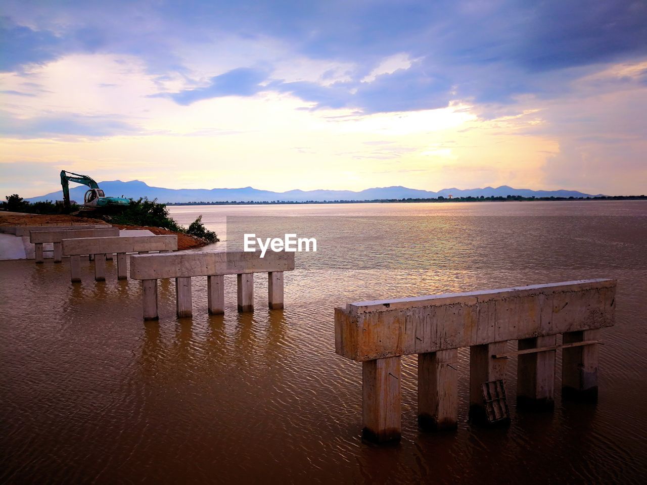 SCENIC VIEW OF BEACH AT SUNSET