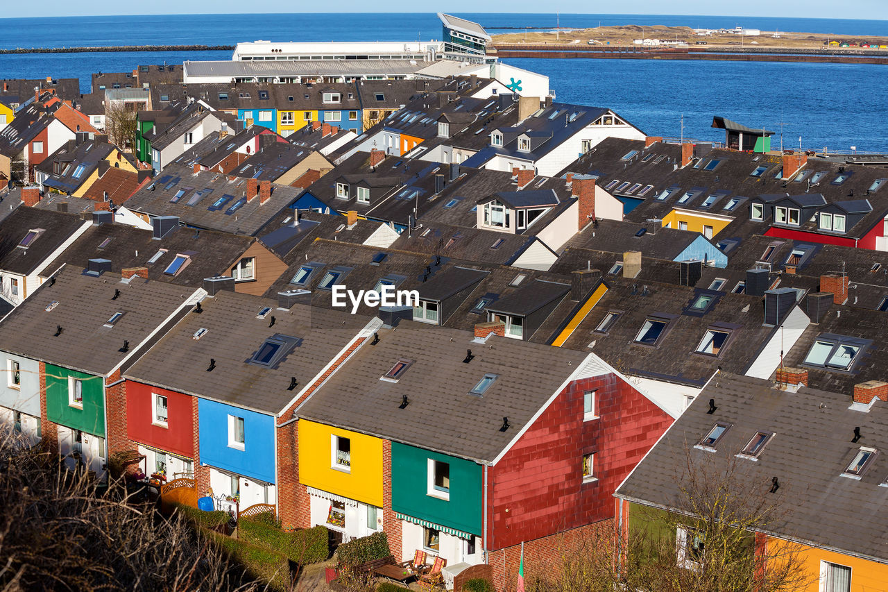 High angle view of houses by sea in town