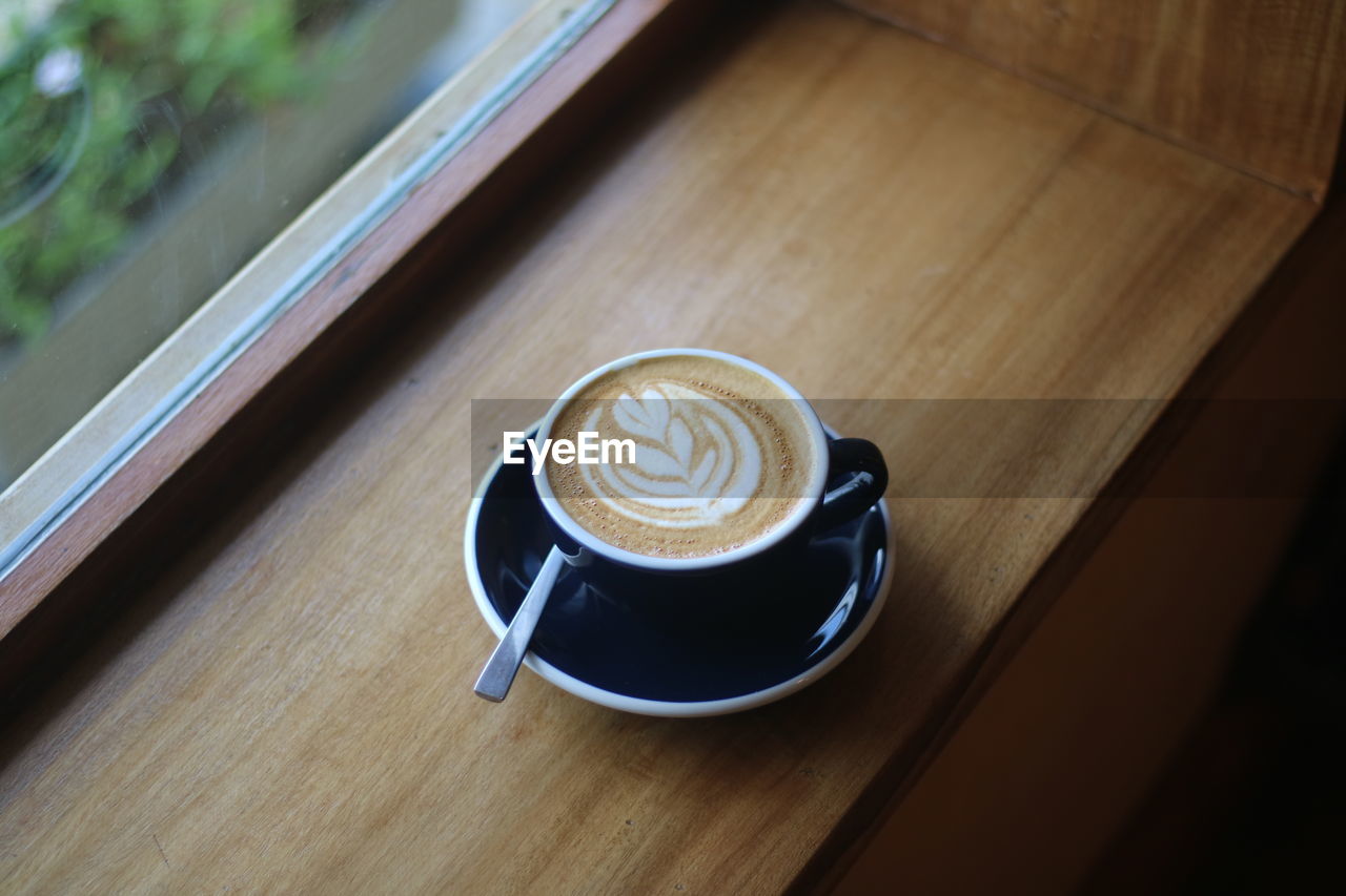 coffee, drink, coffee cup, mug, cup, refreshment, food and drink, cappuccino, frothy drink, hot drink, table, crockery, saucer, froth art, still life, wood, indoors, latte, high angle view, no people, cafe, freshness