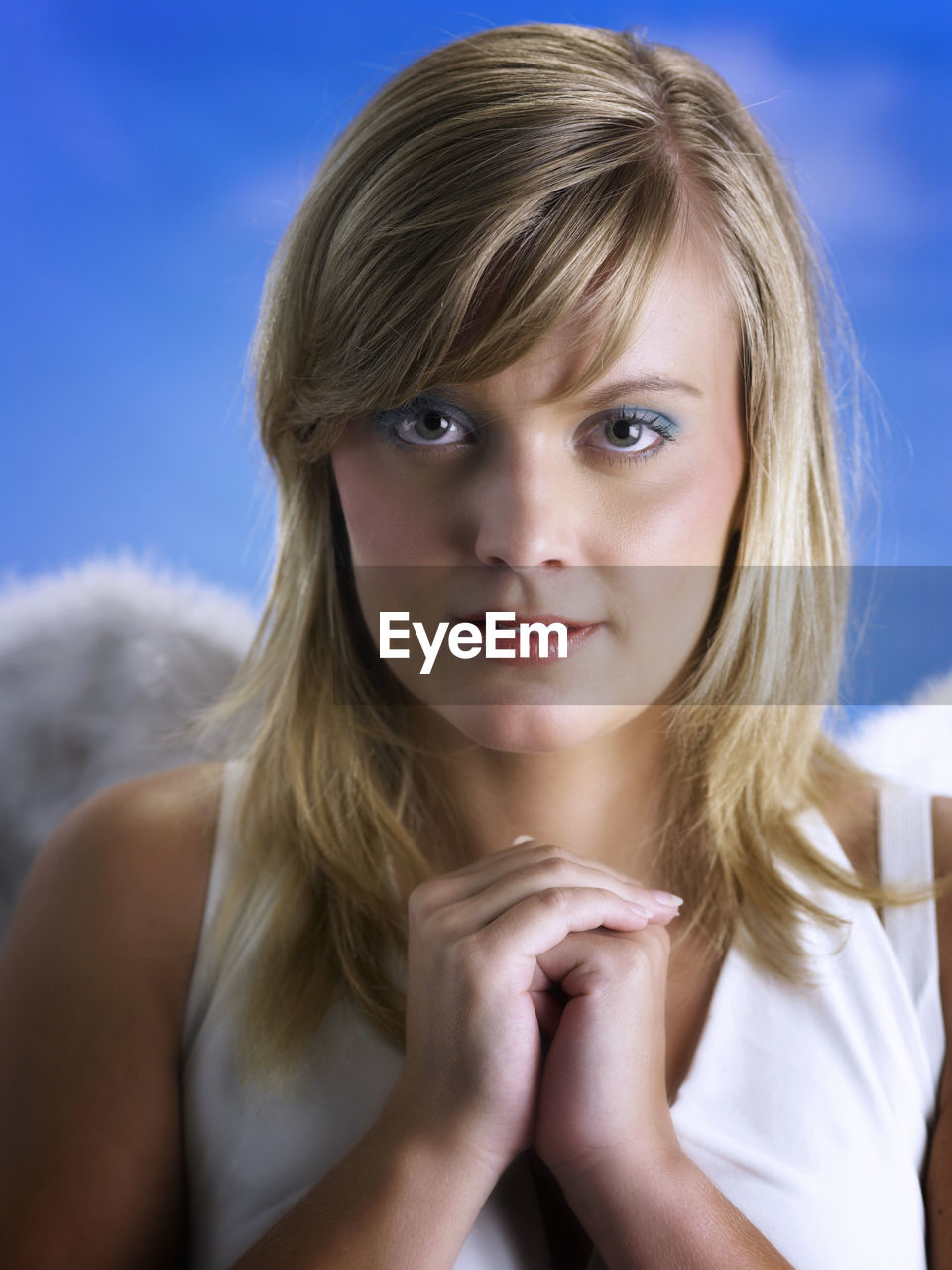 Portrait of beautiful young woman wearing angel wings