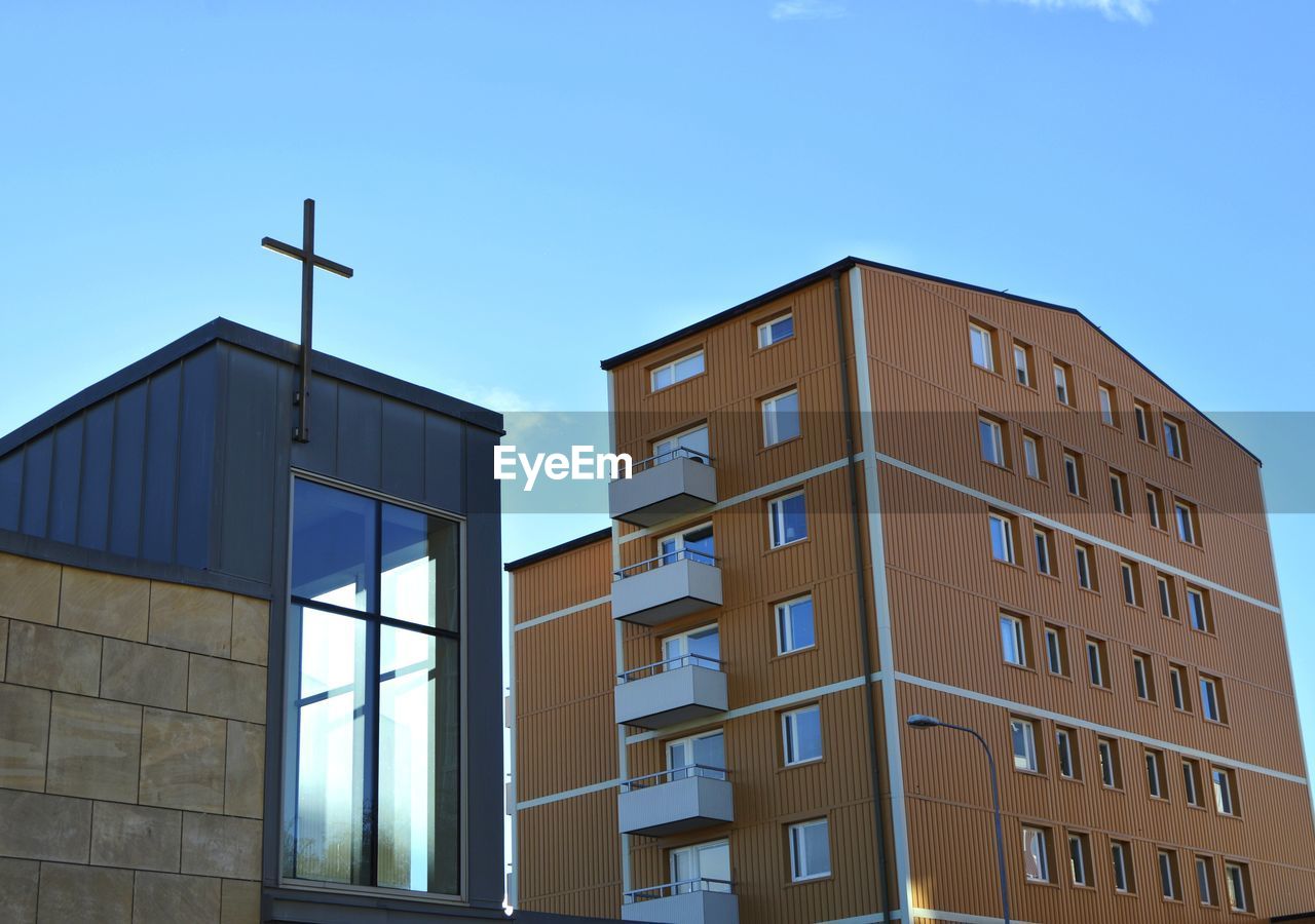 Low angle view of modern building against clear blue sky