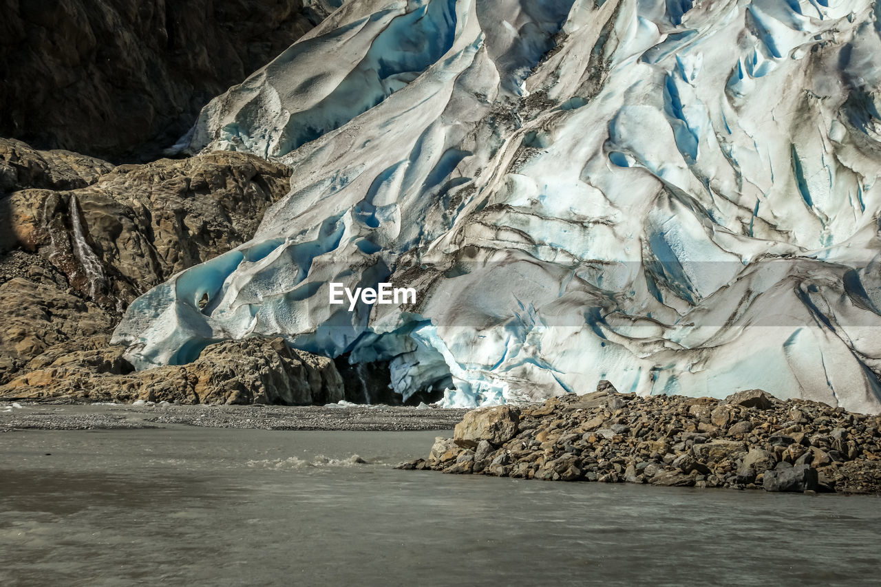 Scenic view of frozen lake against rocks