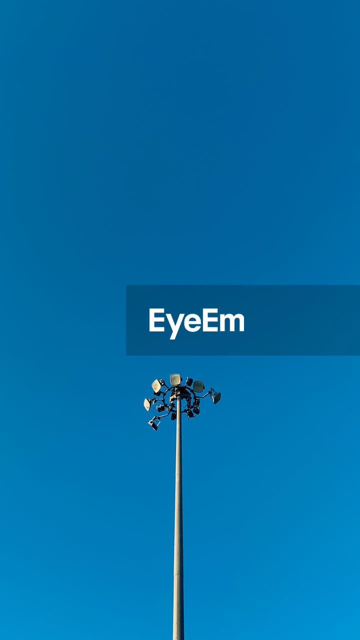 Low angle view of street light against clear blue sky