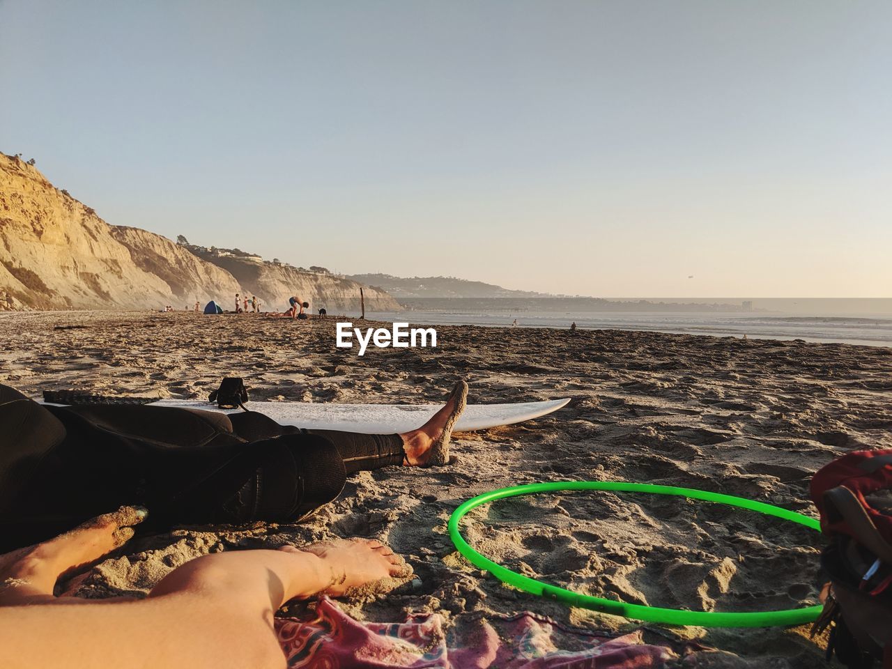 GROUP OF PEOPLE ON BEACH AGAINST CLEAR SKY