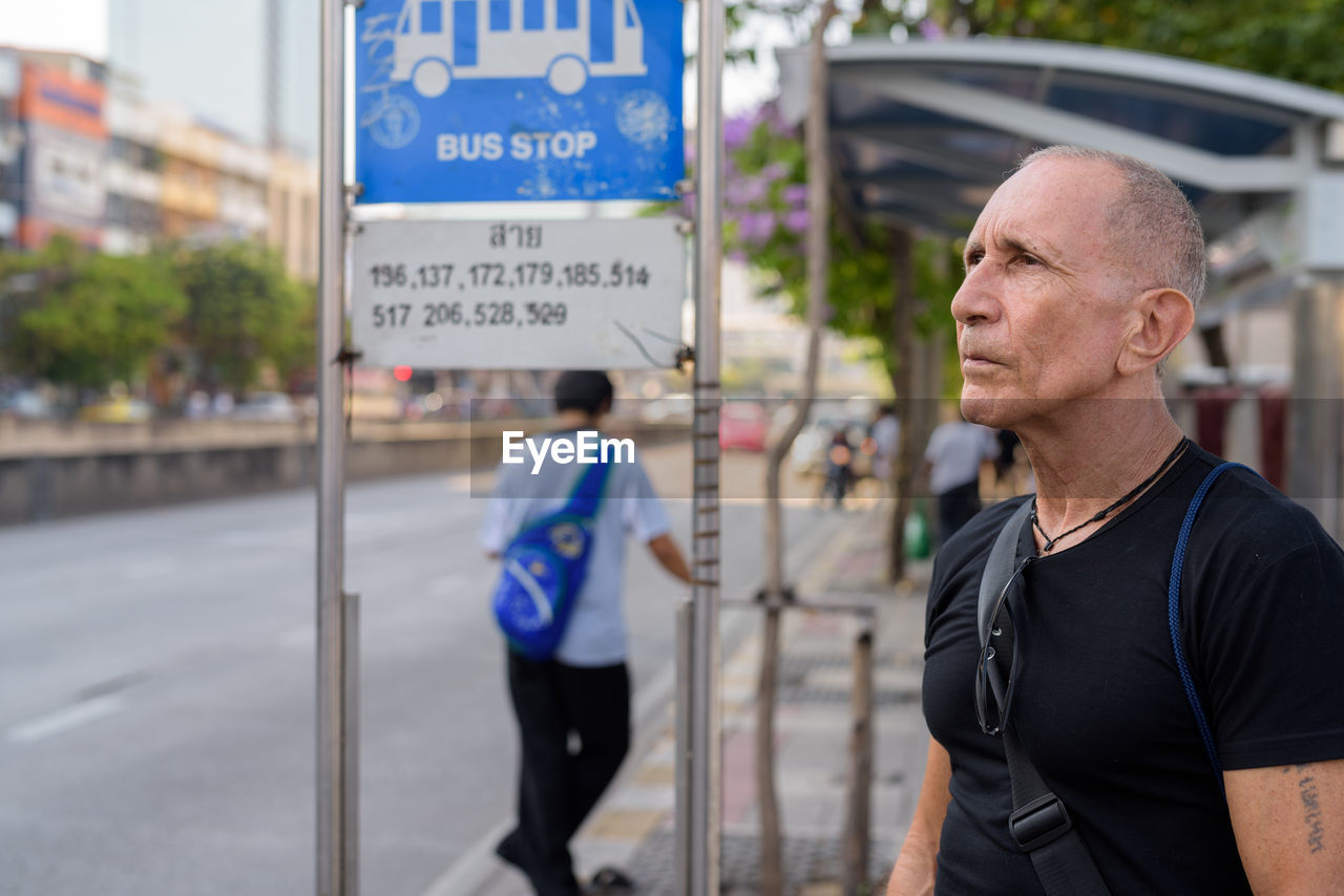 Man standing at bus stop