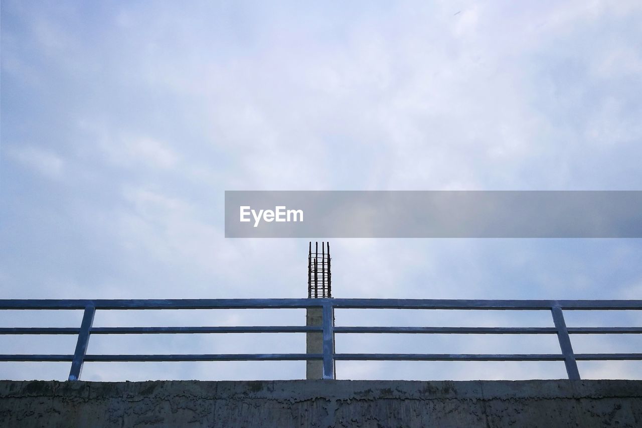 Low angle view of bridge over water against sky